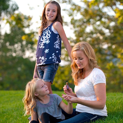 Mother and children enjoying essential oils outdoors